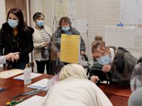 Voters communicate with poll wokers through the plexi glass barriers insalled at the Dartmouth Town Hall polling station.  [ PETER PEREIRA/THE STANDARD-TIMES/SCMG ]