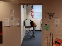 A voter casts his vote inside of the Dartmouth Town Hall polling station in Dartmouth.  [ PETER PEREIRA/THE STANDARD-TIMES/SCMG ]