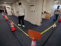 Voters make their way to the voting booths by walking through the inside/outside lanes set up inside of the Dartmouth Town Hall polling station.   [ PETER PEREIRA/THE STANDARD-TIMES/SCMG ]