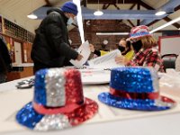 Poll workers get into the spirit of the occasion, as voters check-in to receive their ballots for the 2020 Presidential election inside of the Buttonwood warming house polling station in New Bedford.  [ PETER PEREIRA/THE STANDARD-TIMES/SCMG ]