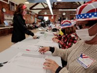 First time voter, Alexia Vieira, retrieves her ballot to cast her vot for the 2020 Presidential election at the Buttonwood Warming House polling station in New Bedford.  [ PETER PEREIRA/THE STANDARD-TIMES/SCMG ]