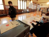 First time voter Brody Hunt, 18, leaves after casting his ballot for the 2020 Presidential election at Fairhaven Town Hall.  [ PETER PEREIRA/THE STANDARD-TIMES/SCMG ]