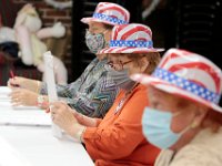 Poll workers get into the spirit of the occasion inside of the Buttonwood warming house polling station in New Bedford.