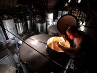 Winemaker Marco Montez uses a light and his hand to 'scoop' up air for his daily sample of the smell inside the tanks filled with unfermented pinot noir juice, which will become Westport Rivers 2020 Rose after fermenting as the harvest season gets underway at the Westport Rivers Vineyard & Winery in Westport.  [ PETER PEREIRA/THE STANDARD-TIMES/SCMG ]