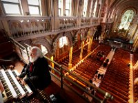 Organist, Thomas Clough Sargent, plays the organ high above as a funerary mass files down below at the St. Anthony's of Padua church in New Bedford, MA on February 17, 2016.