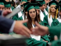 A student who has not received her diploma yet looks on as a classmate receives her diploma at the 2016 Dartmouth High School Graduation on June 5, 2016.