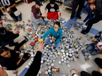 Normandin Middle School eighth grader Adamarys Sierra, 13, is surrounded by cans she is sorting as she and her classmates prepare food baskets to give to the needy for Thanksgiving, with cans they collected throught the school year and turkeys donated by the Friendly Sons of St. Patrick.   PETER PEREIRA/THE STANDARD-TIMES/SCMG