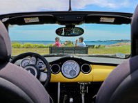 Diane Fortin-Curtin and  Christine Davis enjoy a chat on a bench at Fort Phoenix in Fairhaven as seen through the windshielf of their convertible car.   PETER PEREIRA/THE STANDARD-TIMES/SCMG