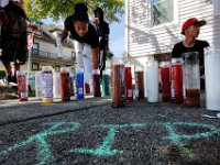 Friends light candles in memory of Mateo Morales at the intersection of Middle Street and Chancery Street in New Bedford, where three men were stabbed.  One of the victims, 15-year old Mateo Morales,  later died from his injuries.   PETER PEREIRA/THE STANDARD-TIMES/SCMG