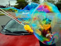 Anna Santos takes advantage of the high winds to blow some bubbles at Fort Phoenix in Fairhaven with a contraption she bought for her nephew.   PETER PEREIRA/THE STANDARD-TIMES/SCMG