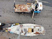 Peter Costa, owner of Triad Boatworks, monitors from the lift truck as George Barringer, gets a hand from Jason Costa of Triad Boatworks, riggin his sailboat the Enterprise,  before putting it in the water in Mattapoisett. PETER PEREIRA/THE STANDARD-TIMES/SCMG