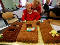 Irene Miller is in disbelief as Lucia Mota presents her with a birthday cake she made for her to celebrate her turning 108 at the Active Day Adult Day Care Center in New Bedford.   PETER PEREIRA/THE STANDARD-TIMES/SCMG