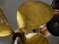 Steven Saraiva of Marine Propeller Services grinds a small propeller he rapaired into shape before putting it on the balancing stand at the Fairhaven shop. PETER PEREIRA/THE STANDARD-TIMES/SCMG