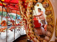 Santiago Pasos is reflected on the mirror as he washes the horses in the merry-go-round ride at the New Bedford Police Union Family Fun Festival held at Buttonwood Park In New Bedford opening Friday to Sunday. PETER PEREIRA/THE STANDARD-TIMES/SCMG