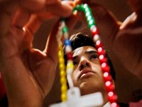 St. James St. John eighth grader, Jameson Lima, 13, counts off the Hail Mary's on the beads of his rosary, as he and other seventh and eighth graders from New Bedford Catholic Schools participate in the annual Rosary Rally held at Bishop Stang High School in Dartmouth.   PETER PEREIRA/THE STANDARD-TIMES/SCMG