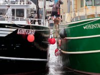 A fisherman leaps from one boat to another as the fishing boat Kathy Jakie prepares to tie off in New Bedford harbor.   PETER PEREIRA/THE STANDARD-TIMES/SCMG