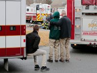 Family and friends look on as firefighters enter the home where Joseph Lopes, 41, and his son Collin Lopes, 9, died of carbon monoxide poisoning on Buttonwood Lane in Acushnet, MA.   PETER PEREIRA/THE STANDARD-TIMES/SCMG