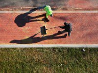 Shadows dance across the brickwork as Jose Carvalho, top, and Dinis Machado, masons with K. DaPonte Construction Company, fill in the joints of the newly paved brick sidewalk they just finished in front of the Unitarian Church in Fairhaven, with sand as the final process before its complete.   PETER PEREIRA/THE STANDARD-TIMES/SCMG