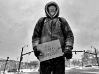 A homeless man stands at the intersection of Route 6 and Purchase Street in downtown New Bedford on a snowy morning. PETER PEREIRA/THE STANDARD-TIMES/SCMG