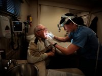 performs an oral cancer screening inside the Southcoast Health van in front of a fish processing plant in the south end of New Bedford.   PETER PEREIRA/THE STANDARD-TIMES/SCMG