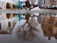 A woman walks by a pond in Mattapoisett, as the high temperatures melt the snowfall that had accumulated since last weeks snow storm.   PETER PEREIRA/THE STANDARD-TIMES/SCMG