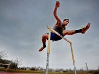 UMAss Dartmouth track athlete Ben Rounseville works on his hurdles under a stormy sky at the university's track in Dartmouth, MA.   PETER PEREIRA/THE STANDARD-TIMES/SCMG