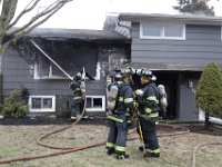 New Bedford firefighters battle a fire at a single family home on Tremont Street in New Bedford.  [ PETER PEREIRA/THE STANDARD-TIMES ]