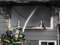 New Bedford firefighters battle a fire at a single family home on Tremont Street in New Bedford.  [ PETER PEREIRA/THE STANDARD-TIMES ]