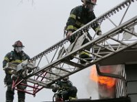 New Bedford firefighters battle a fire at a single family home on Tremont Street in New Bedford.  [ PETER PEREIRA/THE STANDARD-TIMES ]