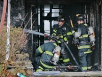 New Bedford firefighters battle a fire at a single family home on Tremont Street in New Bedford.  [ PETER PEREIRA/THE STANDARD-TIMES ]