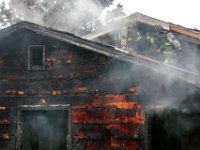 New Bedford firefighters battle a fire at a single family home on Tremont Street in New Bedford.  [ PETER PEREIRA/THE STANDARD-TIMES ]