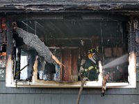 New Bedford firefighters battle a fire at a single family home on Tremont Street in New Bedford.  [ PETER PEREIRA/THE STANDARD-TIMES ]