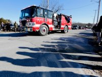 The shadows of students from the Somerset Berkley Regional High School lining the road are seen on the ground, as a Mattapoisett apparatus drives toward Saint Thomas More Church for the funeral mass of Somerset Fire Chief Scott Jepson in Somerset.  Chief Jepson was then buried at the Nathan Slade Cemetery in Somerset.  PHOTO PETER PEREIRA