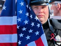 A Somerset Fire Dept. Honor Guard, holds an American flag waiting for the arrival of the hearse for the funeral mass of Somerset Fire Chief Scott Jepson held at Saint Thomas More Church on Luther Avenue in Somerset.  Chief Jepson was then buried at the Nathan Slade Cemetery in Somerset.  PHOTO PETER PEREIRA