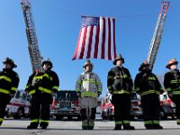 Firefighters from various districts stand at attention in front of the Somerset fire station, waiting for the procession to file past after the funeral mass of Somerset Fire Chief Scott Jepson held at Saint Thomas More Church on Luther Avenue in Somerset.  Chief Jepson was then buried at the Nathan Slade Cemetery in Somerset.  [ PETER PEREIRA/THE STANDARD-TIMES/SCMG ]