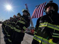 Firefighters from various districts stand at attention in front of the Somerset fire station, waiting for the procession to file past after the funeral mass of Somerset Fire Chief Scott Jepson held at Saint Thomas More Church on Luther Avenue in Somerset.  Chief Jepson was then buried at the Nathan Slade Cemetery in Somerset.  PHOTO PETER PEREIRA