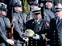 Somerset firefighters carry the helmet of Somerset Fire Chief Scott Jepson after the funeral mass held at Saint Thomas More Church on Luther Avenue in Somerset.  Chief Jepson was then buried at the Nathan Slade Cemetery in Somerset.  PHOTO PETER PEREIRA