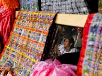 Woman is framed by tradition dresses for sale at a shop in Chinique, Guatemala.