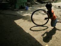 Kevin Andrew Garcia, 3 plays with a bicycle tire in Xicalcal, Guatemala.