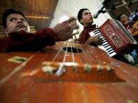 Sunday mass at the Peroquia de Santo Christo church in Zacualpa, Guatemala.  Three brothers and their father play traditional instruments at Mass. Conjunto Boss que clama en el desierto. from Turbala, Guatemala.