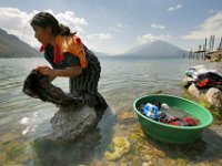 Maria Gomez, 16, orange top, and her friend Isabel Hernandez, 17, perform their daily task of washing their clothes on the shores of Lake Atitlan in Santa Caterina Palopo, Guatemala.
