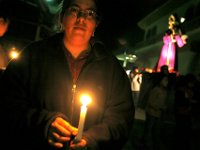 Holding candles and chanting prayers, people file down the tight streets of Chichicastenango as part of a religious procession.  La Procesion de Senor Sepultado.  An event that happens once a year.