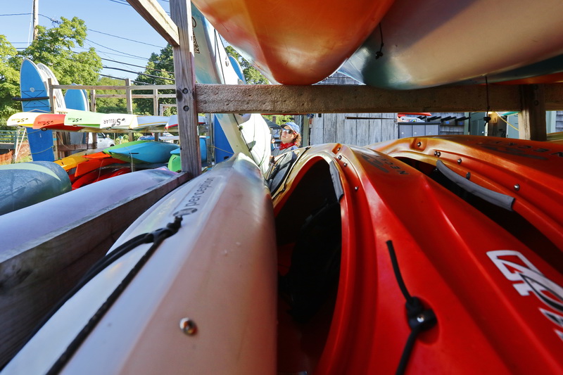 Osprey Sea Kayak instructor, Jon Trzepkowski, prepares the kayaks for the days activities on the Westport River in Westport, MA. PHOTO PETER PEREIRA