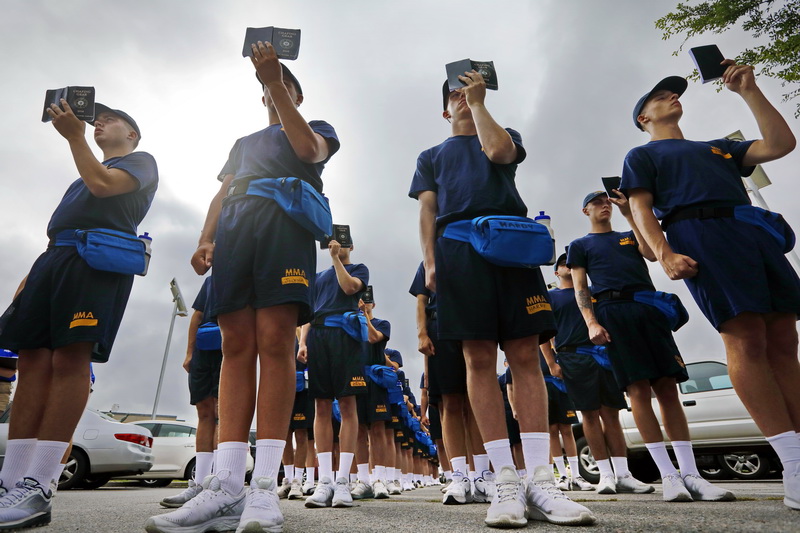 Just arrived Massachusetts Maritime Academy freshmen cadets study their Chafing Gear: Discipline, Knowledge, Leadership manual  while standing at attention, as part of rigorous drills they are forced to perform during their first week at the Buzzards Bay merchant mariner academy. PHOTO PETER PEREIRA