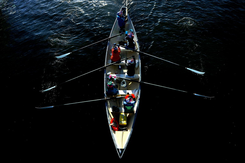 Members of the Buzzards Bay Rowing Club go out for the first row of the new year into the shadow, as they make their way under the Fairhaven Bridge in New Bedford, MA.   PHOTO PETER PEREIRA