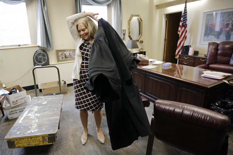 A cart waits to take her personal belongings away from her office as Judge Sabra puts on her robes for the last time to conduct drug court. After 18 years as the presiding judge of New Bedford District Court, Bernadette Sabra will will retire on Jan. 11. She presided over the drug court at New Bedford District Court, a specialty court that emphasizes treatment, testing and monitoring of adjudicated offenders to stop recidivism, for most of her 18 years. The goal of the court, which meets once a week, is to treat an offenders addiction and stop the need to commit crimes.