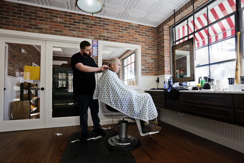 Shawn Lynch gives Raymond  Fava a new haircut at the recently opened Rooney's of  Marion barber shop in Marion, MA.   PHOTO PETER PEREIRA