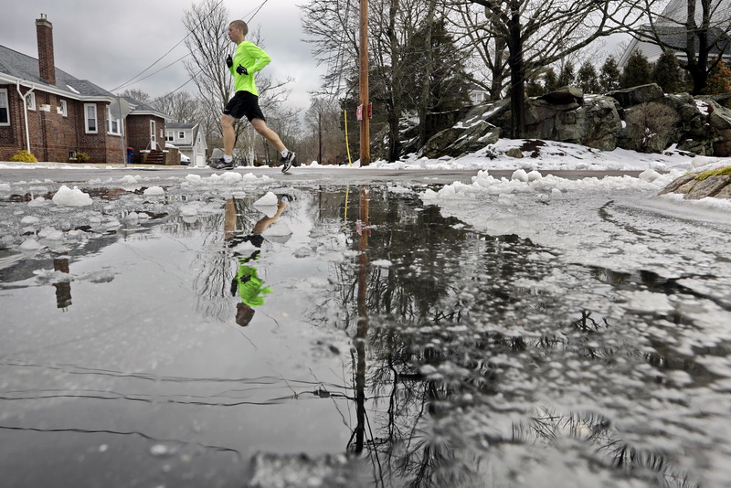 A runner makes his way up Green Street in Fairhaven, MA past the remnants of the snow fall that hit the region yesterday. PHOTO PETER PEREIRA