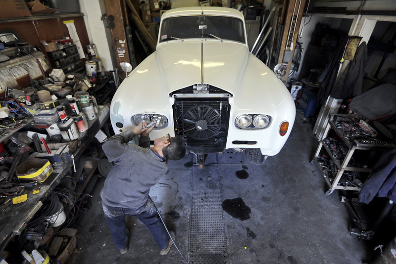 Paulo Carmo works on restoring a 1963 Rolls Royce which will be used by Salon Salon Limousine in Westport, MA.  PHOTO PETER PEREIRA