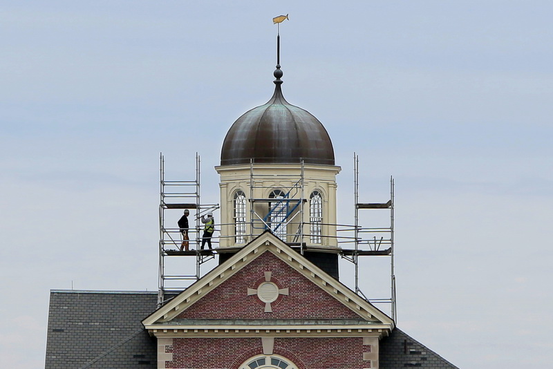 Workmen install the staging around the iconic cupola of the Whaling Museum as part of a new phase of repairs underway at the downtown New Bedford, MA landmark.  PHOTO PETER PEREIRA